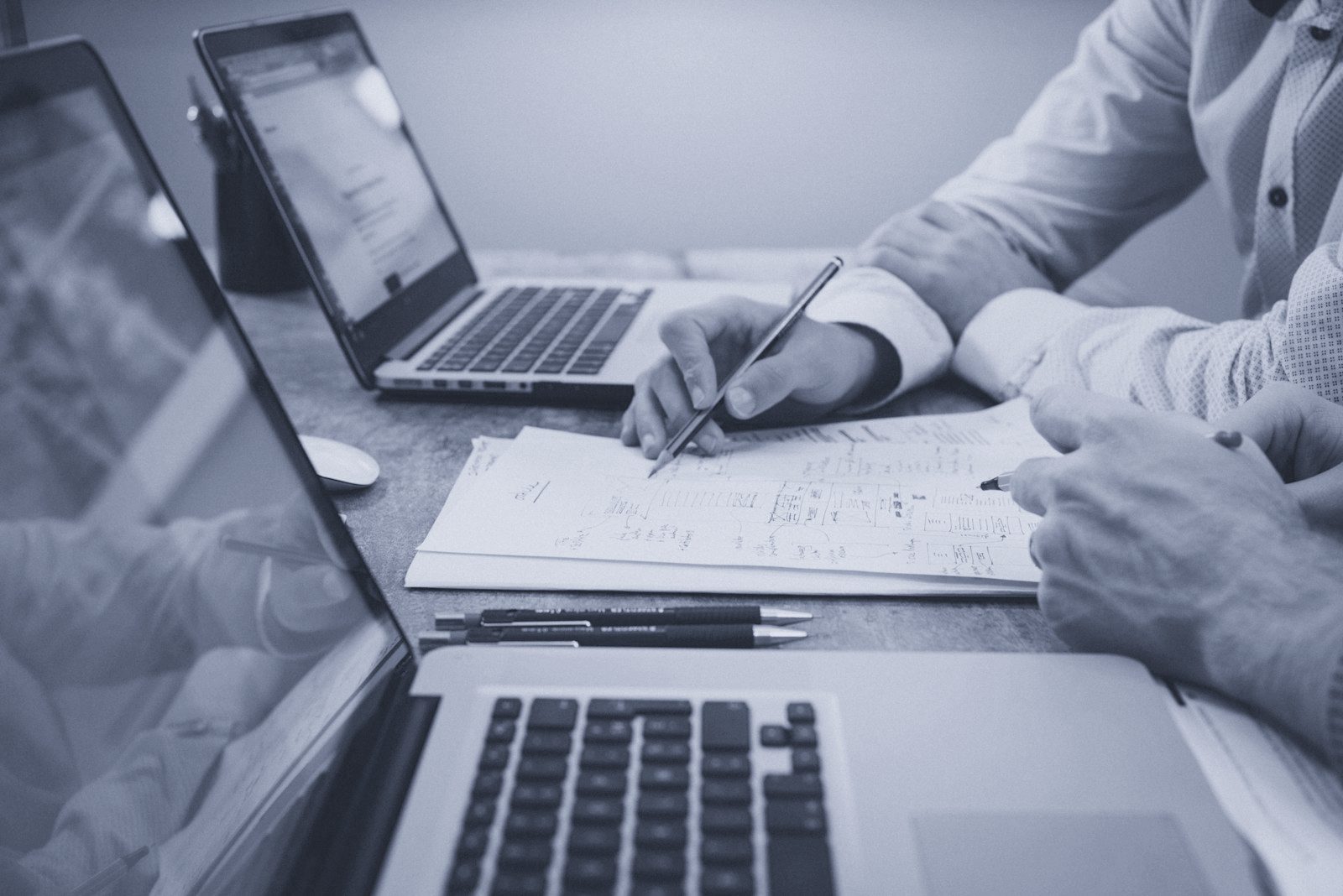 Printed loan portfolio reports and a calculator on a desk in a financial services office